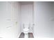 Bathroom with a white toilet, closed white door, and chrome toilet paper holder at 10550 W Alexander Rd # 2057, Las Vegas, NV 89129