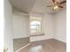 Bright bedroom featuring hardwood floors, a cozy window seat, and a ceiling fan at 10550 W Alexander Rd # 2057, Las Vegas, NV 89129