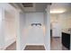 An entryway featuring dark brown flooring, spotlight lighting, and access to the kitchen and bathroom at 10550 W Alexander Rd # 2057, Las Vegas, NV 89129