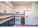 A bright kitchen with white cabinetry, modern appliances, and granite countertops at 10550 W Alexander Rd # 2057, Las Vegas, NV 89129