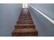 A staircase with wooden steps and white railing leads to the upper level of the home at 10550 W Alexander Rd # 2057, Las Vegas, NV 89129