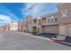 Townhome community with attached garages and well-maintained landscaping, promising curb appeal and convenience at 10550 W Alexander Rd # 2057, Las Vegas, NV 89129