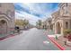 A well-maintained street view showcases the community's architecture and landscaping on a sunny day at 10550 W Alexander Rd # 2057, Las Vegas, NV 89129