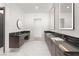 Modern bathroom with dual vanities, sleek fixtures, marble flooring, and well-lit mirrors for a spa-like experience at 1057 Giovanni Ln, Henderson, NV 89012