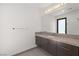 Modern bathroom featuring a long vanity with gray cabinets and a large mirror at 1057 Giovanni Ln, Henderson, NV 89012