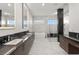 Stunning bathroom featuring double vanity, luxurious soaking tub, glass shower, and marble accents throughout at 1057 Giovanni Ln, Henderson, NV 89012