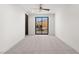 Bright carpeted bedroom with modern sliding glass doors providing access to a private outdoor courtyard at 1057 Giovanni Ln, Henderson, NV 89012