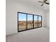 Carpeted bedroom featuring a ceiling fan and large sliding glass doors providing natural light and scenic views at 1057 Giovanni Ln, Henderson, NV 89012