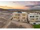 Contemporary two-story home featuring large windows, balconies, desert landscaping, and views of the valley at 1057 Giovanni Ln, Henderson, NV 89012