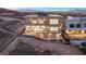 A modern two-story home with balconies, desert landscaping, and stunning mountain views at 1057 Giovanni Ln, Henderson, NV 89012