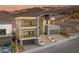 Modern three-story home featuring multiple balconies, a three-car garage, and well-manicured landscaping at 1057 Giovanni Ln, Henderson, NV 89012