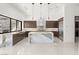 Gourmet kitchen featuring a waterfall island, stainless steel appliances, and marble countertops at 1057 Giovanni Ln, Henderson, NV 89012