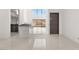Minimalist kitchen with a waterfall island and glass-enclosed dining space at 1057 Giovanni Ln, Henderson, NV 89012