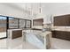 Modern kitchen with marble countertops, stainless steel appliances, and an oversized kitchen island at 1057 Giovanni Ln, Henderson, NV 89012