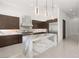 Contemporary kitchen featuring stainless steel appliances, a waterfall island, and custom cabinetry at 1057 Giovanni Ln, Henderson, NV 89012