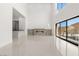 Open-concept living area with fireplace, wet bar, and walls of windows showcasing the mountain views at 1057 Giovanni Ln, Henderson, NV 89012