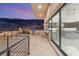 Modern outdoor kitchen with stainless steel appliances, marble countertop and mountain views at twilight at 1057 Giovanni Ln, Henderson, NV 89012