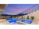 Beautifully landscaped pool and spa area, perfect for relaxation and entertainment at dusk at 1057 Giovanni Ln, Henderson, NV 89012