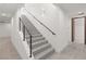Modern staircase with sleek handrails leading to the upper level, complemented by stylish lighting at 1057 Giovanni Ln, Henderson, NV 89012