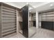 Expansive walk-in closet with custom shelving, mirrored accents, and ample storage space, ideal for organization at 1057 Giovanni Ln, Henderson, NV 89012