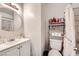 Cozy bathroom featuring a sleek vanity, commode, and shower with modern fixtures at 1228 Mews Ln, Las Vegas, NV 89101