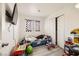 Playful bedroom with a race car bed, laminate wood floors, and a window with decorative curtains at 1228 Mews Ln, Las Vegas, NV 89101