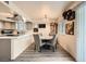 Cozy dining area adjacent to the kitchen, featuring modern light fixtures and a view of the backyard at 1228 Mews Ln, Las Vegas, NV 89101