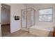 En-suite bathroom with glass-enclosed shower, soaking tub, and wood look flooring at 1270 Del Lilly Ln, Las Vegas, NV 89123