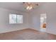 Carpeted bedroom with neutral walls, a ceiling fan, and a window for natural light at 1270 Del Lilly Ln, Las Vegas, NV 89123