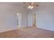 Spacious bedroom with plush carpeting, ceiling fan, and access to ensuite bathroom at 1270 Del Lilly Ln, Las Vegas, NV 89123