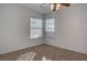 Bright bedroom featuring dual windows providing natural light and plush carpeting at 1270 Del Lilly Ln, Las Vegas, NV 89123