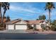 Charming single-story home featuring a three-car garage and a beautifully landscaped front yard with mature palm trees at 1270 Del Lilly Ln, Las Vegas, NV 89123
