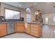 Light wood kitchen with stainless steel appliances, granite countertops, and an island cooktop at 1270 Del Lilly Ln, Las Vegas, NV 89123