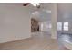 Spacious living room features a floor-to-ceiling stone fireplace, new floors, and ample natural light at 1270 Del Lilly Ln, Las Vegas, NV 89123