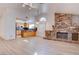 Inviting living room area with a stone fireplace, an open layout, and seamlessly connecting to the kitchen at 1270 Del Lilly Ln, Las Vegas, NV 89123