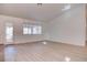 Bright living room with wood-look floors, glass paneled exterior door, and natural light at 1270 Del Lilly Ln, Las Vegas, NV 89123