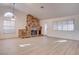 Spacious living room features a floor-to-ceiling stone fireplace, new floors, and ample natural light at 1270 Del Lilly Ln, Las Vegas, NV 89123