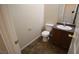 Powder room with a toilet, sink with a dark wood cabinet, and a mirror at 1286 Horizon Village Ave, Las Vegas, NV 89183