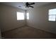 Bedroom with neutral carpet, ceiling fan, and three bright windows at 1286 Horizon Village Ave, Las Vegas, NV 89183