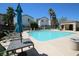 Community pool with lounge chairs, tables, and palm trees for a relaxing atmosphere at 1286 Horizon Village Ave, Las Vegas, NV 89183