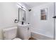 Modern bathroom features a vanity, toilet, mirror, and a shower-tub combination at 1401 E Clark Ave, Las Vegas, NV 89101