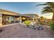 Backyard view features a covered patio, pool, desert landscaping, and outdoor seating, perfect for entertaining at 1657 Hartley Ave, Henderson, NV 89052