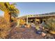 Desert landscape with a covered patio, pool and fountain for outdoor enjoyment at 1657 Hartley Ave, Henderson, NV 89052