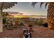 Beautiful backyard with desert landscaping and stunning mountain views at sunset at 1657 Hartley Ave, Henderson, NV 89052