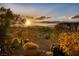 Backyard with desert landscaping, mountain views, and a serene sunset at 1657 Hartley Ave, Henderson, NV 89052