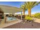 Beautiful backyard oasis featuring a covered patio, desert landscape and a private pool at 1657 Hartley Ave, Henderson, NV 89052