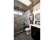 Modern bathroom featuring patterned tile, a glass enclosed shower, skylight, and rustic wood ceiling at 1657 Hartley Ave, Henderson, NV 89052