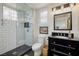 This bathroom features a glass walk-in shower and black granite countertop at 1657 Hartley Ave, Henderson, NV 89052