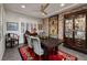 Elegant dining room with stone accent wall, designer lighting, and shuttered windows at 1657 Hartley Ave, Henderson, NV 89052