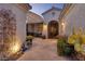 Inviting front entrance with an iron gate, desert plants, and a covered pergola at 1657 Hartley Ave, Henderson, NV 89052
